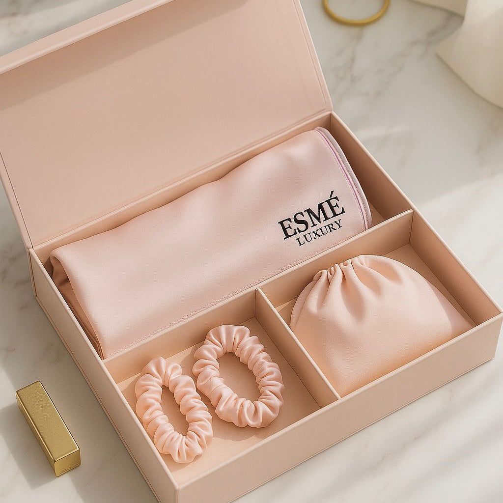 Pink hair accessory set with 'Esme Luxury' branding in an open box on a marble surface.